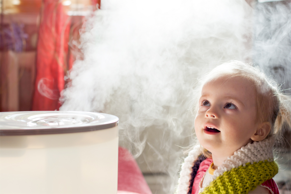 little girl learning to how to use a humidifier